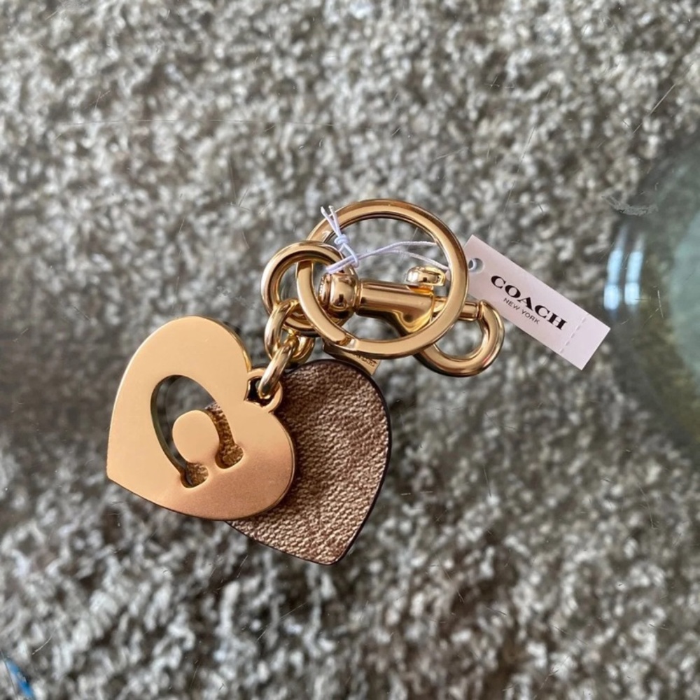 Brand new Coach signature and gold keychain.